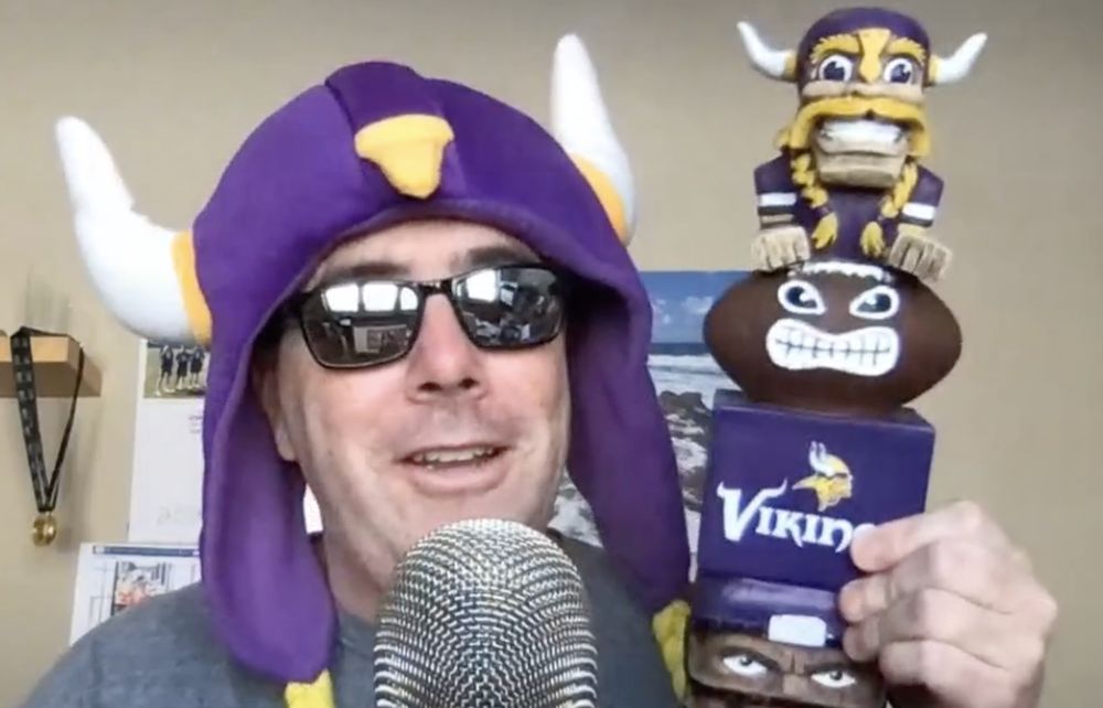 John Nemo on camera in a Vikings horn hat and sunglasses